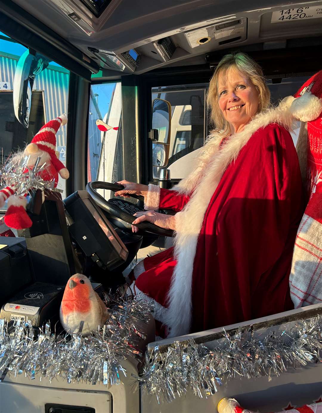 Mrs Claus, aka, Tracy Robinson on her Santa bus