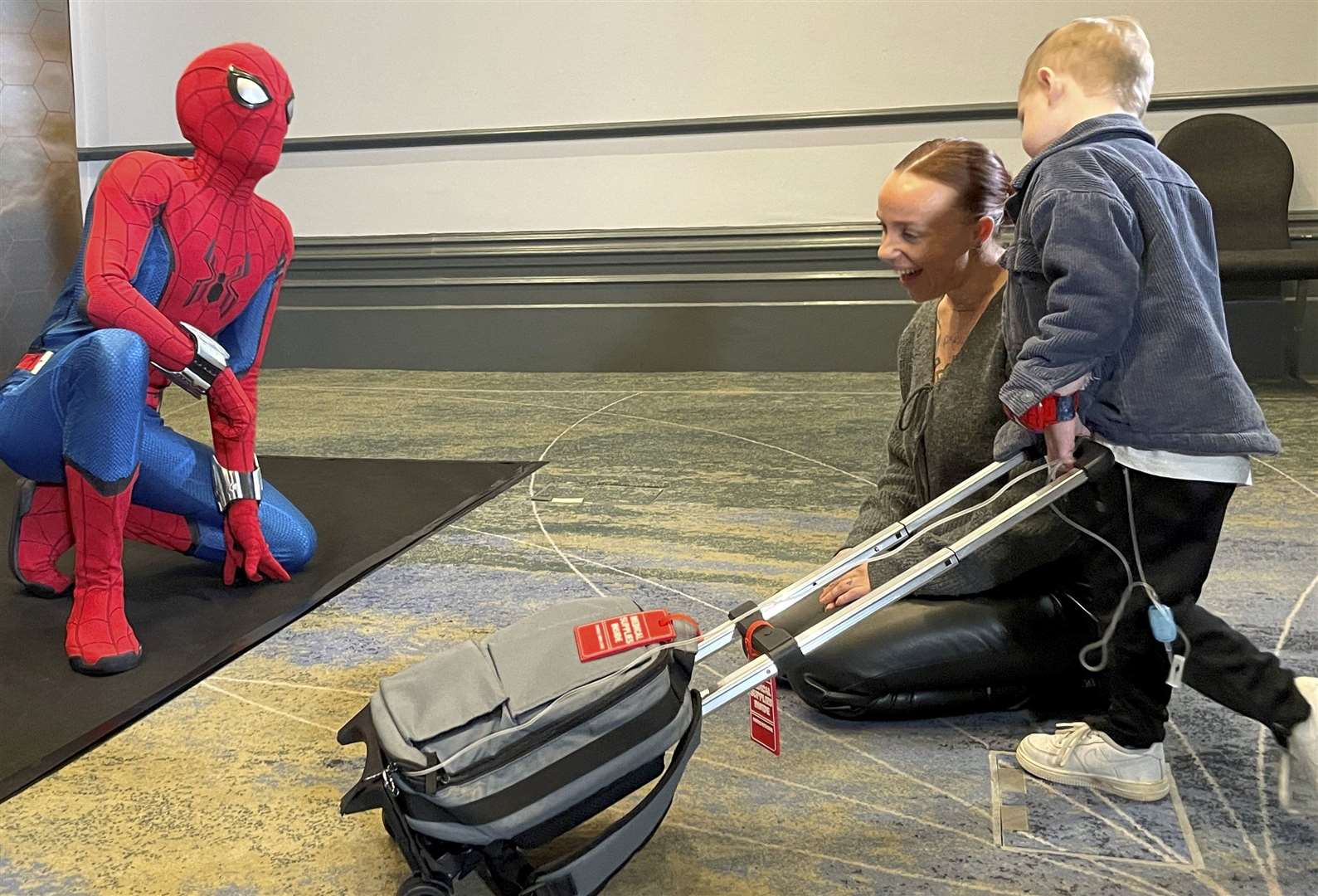 Maidstone boy Henley Mountford-Farmer, who was born with gastroschisis, with mum Kali Mountford-Farmer meeting Spider-Man. Picture: SWNS