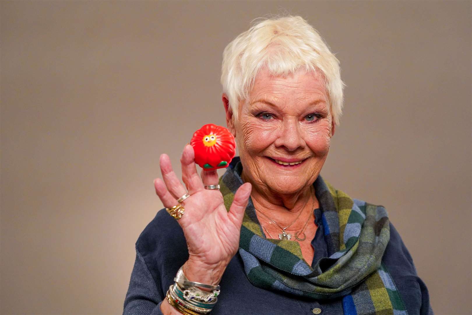 Dame Judi Dench pictured with an earlier Red Nose Day design. Image: Comic Relief.