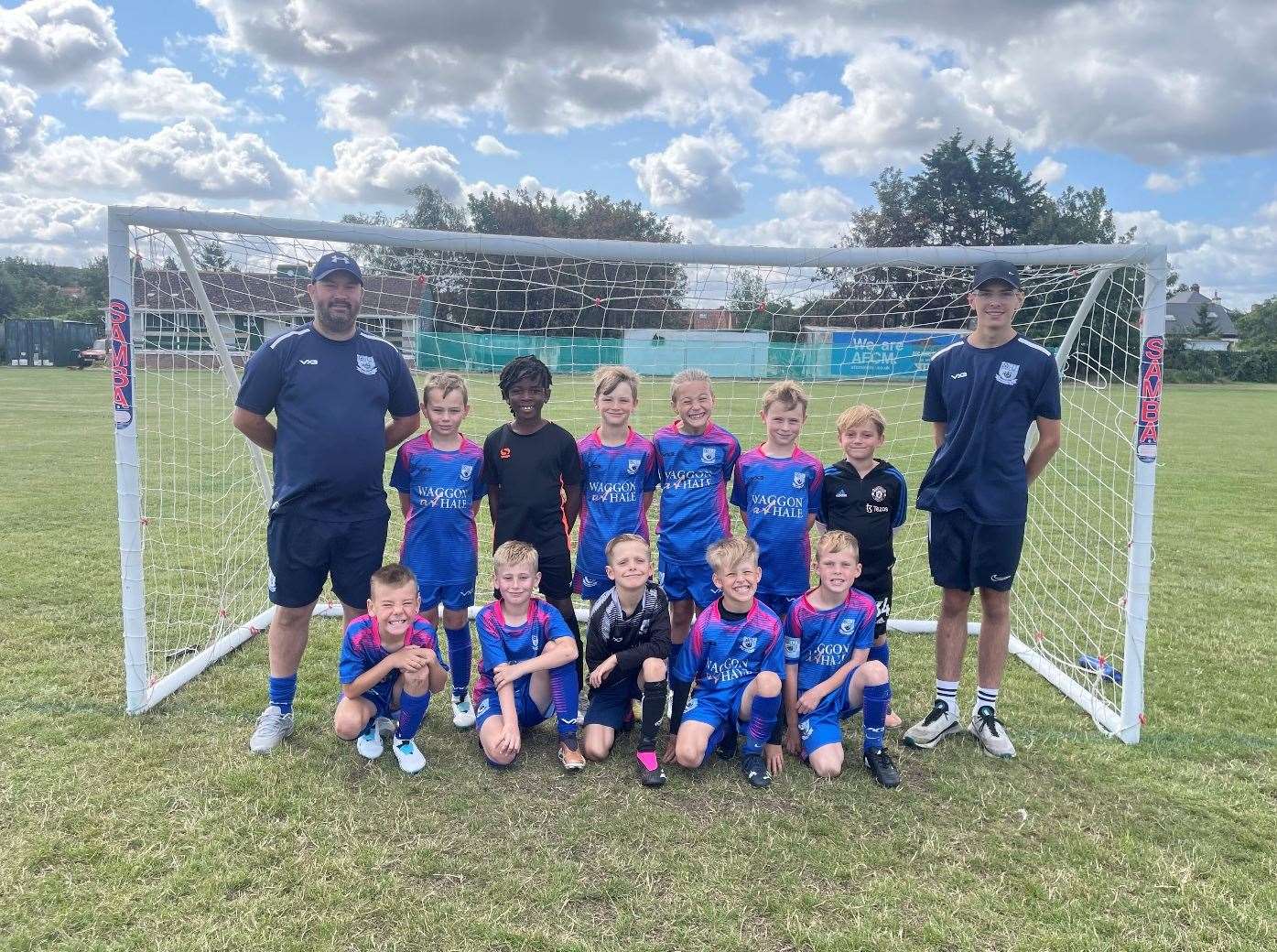 Mitchell Bonney with his assistant manager and 16-year-old son Callum alongside Upchurch Colts Under 8s players. Picture: Mitchell Bonney